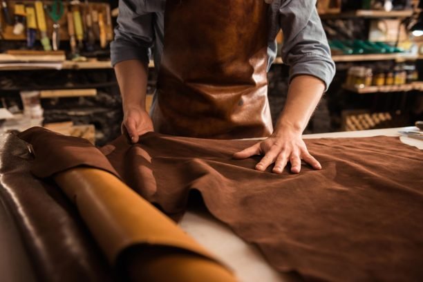 close-up-cobbler-working-with-leather-textile-min