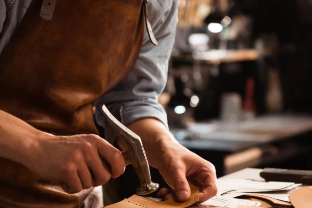close-up-shoemaker-man-working-with-leather-min
